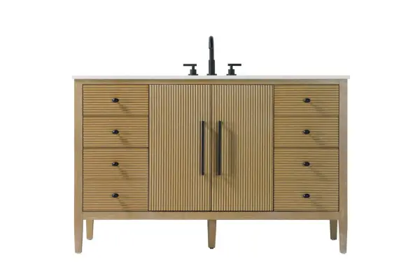 Designed with transitional elegance in mind, this bathroom vanity seamlessly blends traditional elements with modern functionality. Available in five stunning finishes, from the clean sophistication of Crisp White to the natural warmth of Honey Oak, the fluted door and drawer panels add subtle texture and charm. The white engineered marble countertop with natural veining exudes luxury, while the soft-closing doors and drawers with sleek black metal pulls offer a quiet, refined experience. Practicality is never compromised, with features like the U-shaped shelf for plumbing, deeper bottom drawer for ample storage, and pre-drilled faucet holes for easy customization. Whether your style leans modern or classic, this vanity is the perfect balance of beauty and function, appealing to customers with a taste for quality and style. Collection: Blakely Rooms: bathroom Finish: Linen Oak Width: 21.50" Height: 34.00" Length: 54.00" Weight: 217.00 lb Material: Solid wood and MDF Country of Origin: Vietnam Manufacturer Warranty: 1 year limited
