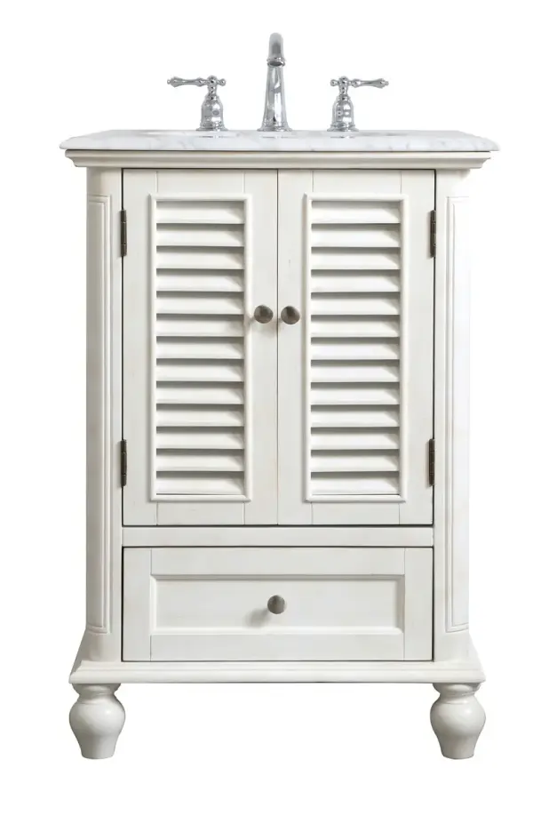 A small space doesn't mean you have to settle for less. The Rhodes collection compact vanity in an antique white finish will add lovely sophistication and complement any small bathroom or powder room, while utilizing its charm and function to provide you with ample storage spaces. Brushed nickel knobs gently adorn the shuttered cabinet doors and drawer at the base, allowing for you to store away your bathroom essentials. The Carrara white marble countertop, porcelain undermount sink, dignified subtle engravings on the side edges, and rounded legs all come together to create contemporary beauty. Work with your space, and design a beautiful room, no matter the size. Collection: Rhodes Rooms: bathroom Finish: antique white Width: 22.00" Height: 35.00" Length: 24.00" Weight: 99.00 lb Material: solid wood and mdf Country of Origin: Vietnam Manufacturer Warranty: 1 year limited Spec Sheet