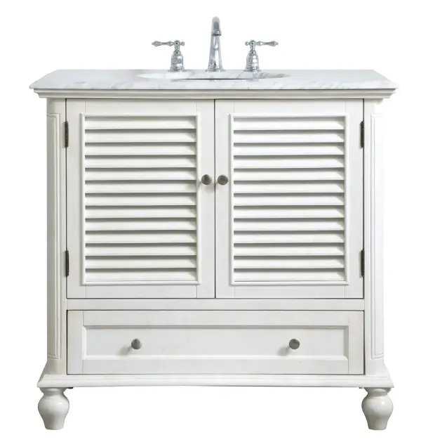 Never compromise beauty--the Rhodes collection stunning vanity in an antique white finish will add lovely sophistication and complement any bathroom or powder room, while utilizing its charm and function to provide you with ample storage spaces. Brushed nickel knobs gently adorn the shuttered cabinet doors and long drawer at the base, allowing for you to store away your bathroom essentials. The Carrara white marble countertop, porcelain undermount sink, dignified subtle engravings on the side edges, and rounded legs all come together to create contemporary beauty. Work with your space, and design a beautiful room, no matter the size. Collection: Rhodes Rooms: bathroom Finish: antique white Width: 22.00" Height: 35.00" Length: 36.00" Weight: 136.00 lb Material: solid wood and mdf Country of Origin: Vietnam Manufacturer Warranty: 1 year limited Spec Sheet