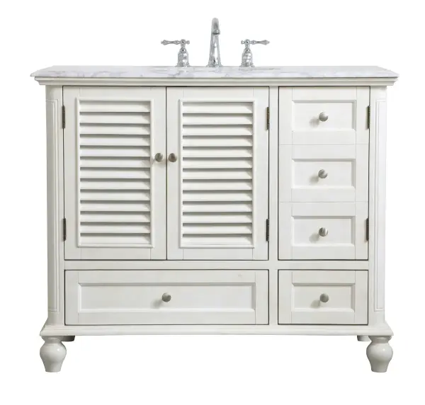 Never compromise beauty--the Rhodes collection stunning vanity in an antique white finish will add lovely sophistication and complement any bathroom or powder room, while utilizing its charm and function to provide you with ample storage spaces. Brushed nickel knobs gently adorn the two drawers at the base and the two shuttered cabinet doors, and the delightful surprising "hidden" cabinet door. Disguised as three drawers, the third cabinet door opens to reveal a space within. These storage areas allows for you to store away your bathroom essentials. The Carrara white marble countertop, porcelain undermount sink, dignified subtle engravings on the side edges, and rounded legs all come together to create contemporary beauty. Work with your space, and design a beautiful room, no matter the size. Collection: Rhodes Rooms: bathroom Finish: antique white Width: 22.00" Height: 35.00" Length: 42.00" Weight: 163.00 lb Material: solid wood and mdf Country of Origin: Vietnam Manufacturer Warranty: 1 year limited Spec Sheet
