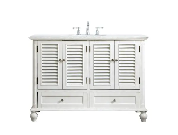 Never compromise beauty--the Rhodes collection stunning vanity in an antique white finish will add lovely sophistication and complement any bathroom or powder room, while utilizing its charm and function to provide you with ample storage spaces. Brushed nickel knobs gently adorn the four shuttered cabinet doors and two long drawers at the base, allowing for you to store away your bathroom essentials. The Carrara white marble countertop, porcelain undermount sink, dignified subtle engravings on the side edges, and rounded legs all come together to create contemporary beauty. Work with your space, and design a beautiful room, no matter the size. Collection: Rhodes Rooms: bathroom Finish: antique white Width: 22.00" Height: 35.00" Length: 48.00" Weight: 172.00 lb Material: solid wood and mdf Country of Origin: Vietnam Manufacturer Warranty: 1 year limited Spec Sheet