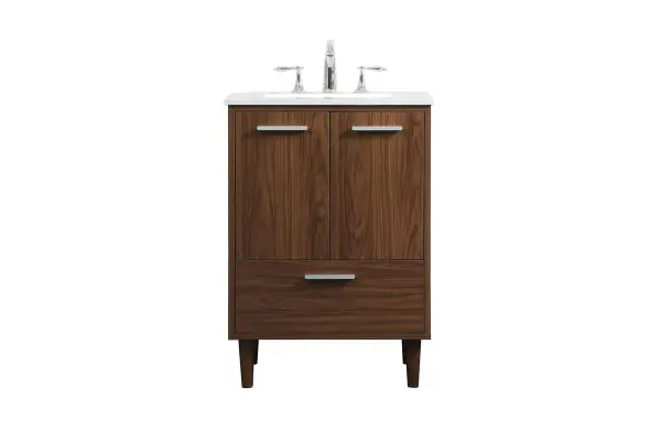 Modern sophistication is defined with the walnut finish and silver barpulls of this vanity and slender tapered legs. Its length makes it the perfect addition to any sized home, and saves space with its storage area hidden behind the double cabinet doors and one bottom drawer. Topped with a highly durable engineered stone countertop and a porcelain undermount sink, this modern design will become your focal point of your bathroom or powder room. Equipped with soft-closing drawer and doors adds a quiet functional touch. Collection: Baldwin Rooms: Bathroom Finish: Walnut Width: 19.00" Height: 34.00" Length: 24.00" Weight: 95.00 lb Material: Solid wood and MDF Country of Origin: Malaysia Manufacturer Warranty: 1 year limited Spec Sheet