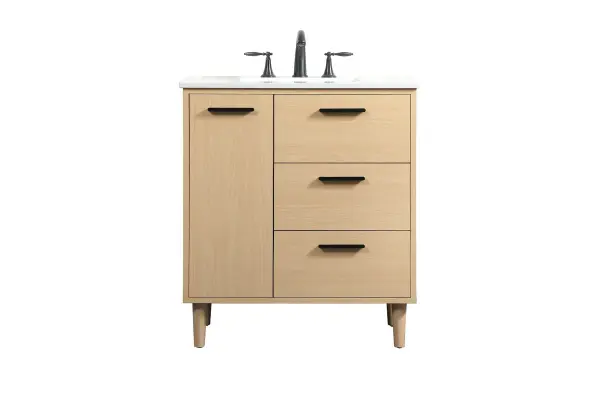 Modern sophistication is defined with the mape finish and black barpulls of this vanity and slender tapered legs. Its length makes it the perfect addition to any sized home, and saves space with its storage area hidden behind the Single cabinet door and two bottom drawers. Topped with a highly durable engineered stone countertop and a porcelain undermount sink, this modern design will become your focal point of your bathroom or powder room. Equipped with soft-closing drawer and doors adds a quiet functional touch. Collection: Baldwin Rooms: Bathroom Finish: Maple Width: 19.00" Height: 34.00" Length: 30.00" Weight: 120.00 lb Material: Solid wood and MDF Country of Origin: Malaysia Manufacturer Warranty: 1 year limited Spec Sheet