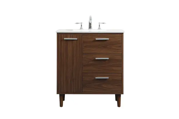 Modern sophistication is defined with the walnut finish and silver barpulls of this vanity and slender tapered legs. Its length makes it the perfect addition to any sized home, and saves space with its storage area hidden behind the Single cabinet door and two bottom drawers. Topped with a highly durable engineered stone countertop and a porcelain undermount sink, this modern design will become your focal point of your bathroom or powder room. Equipped with soft-closing drawer and doors adds a quiet functional touch. Collection: Baldwin Rooms: Bathroom Finish: Walnut Width: 19.00" Height: 34.00" Length: 30.00" Weight: 120.00 lb Material: Solid wood and MDF Country of Origin: Malaysia Manufacturer Warranty: 1 year limited Spec Sheet