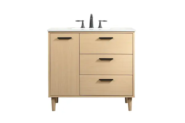 Modern sophistication is defined with the mape finish and black barpulls of this vanity and slender tapered legs. Its length makes it the perfect addition to any sized home, and saves space with its storage area hidden behind the Single cabinet door and two bottom drawers. Topped with a highly durable engineered stone countertop and a porcelain undermount sink, this modern design will become your focal point of your bathroom or powder room. Equipped with soft-closing drawer and doors adds a quiet functional touch. Collection: Baldwin Rooms: Bathroom Finish: Maple Width: 22.00" Height: 34.00" Length: 36.00" Weight: 143.00 lb Material: Solid wood and MDF Country of Origin: Malaysia Manufacturer Warranty: 1 year limited Spec Sheet