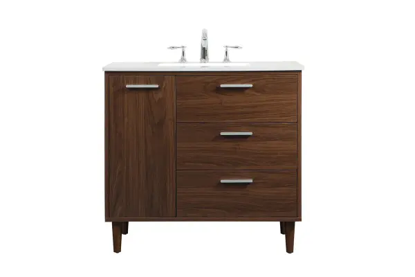Modern sophistication is defined with the walnut finish and silver barpulls of this vanity and slender tapered legs. Its length makes it the perfect addition to any sized home, and saves space with its storage area hidden behind the Single cabinet door and two bottom drawers. Topped with a highly durable engineered stone countertop and a porcelain undermount sink, this modern design will become your focal point of your bathroom or powder room. Equipped with soft-closing drawer and doors adds a quiet functional touch. Collection: Baldwin Rooms: Bathroom Finish: Walnut Width: 22.00" Height: 34.00" Length: 36.00" Weight: 143.00 lb Material: Solid wood and MDF Country of Origin: Malaysia Manufacturer Warranty: 1 year limited Spec Sheet