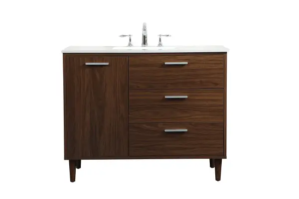 Modern sophistication is defined with the walnut finish and silver barpulls of this vanity and slender tapered legs. Its length makes it the perfect addition to any sized home, and saves space with its storage area hidden behind the Single cabinet door and two bottom drawers. Topped with a highly durable engineered stone countertop and a porcelain undermount sink, this modern design will become your focal point of your bathroom. Equipped with soft-closing drawer and doors adds a quiet functional touch. Collection: Baldwin Rooms: Bathroom Finish: Walnut Width: 22.00" Height: 34.00" Length: 42.00" Weight: 165.00 lb Material: Solid wood and MDF Country of Origin: Malaysia Manufacturer Warranty: 1 year limited Spec Sheet