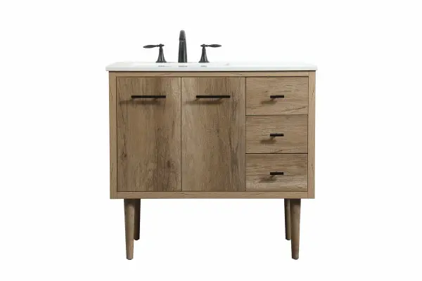 Delve into a world of minimalistic fashion and contemporary styling with this midcentury modern vanity. The clean lines anchors the design, while the straight tapered cylinder legs add subtle interest. Bar pull handle adorns the soft closing door hiding the base of the rectangular porcelain sink and letting you store your bathroom necessities and toiletries. Three soft closing drawers add plenty of storage option. Whether you want to use this as a floating vanity or a freestanding vanity, the choice is yours. The durable ivory white engineered marble countertop complements the manufactured wood base vanity and is built to last. Collection: Cyrus Rooms: bathroom Finish: Natural oak Width: 22.00" Height: 33.50" Length: 36.00" Weight: 127.00 lb Material: Solid wood and MDF Country of Origin: Vietnam Manufacturer Warranty: 1 year limited