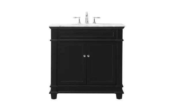 The Wesley Collection vanity cabinet will bring a settle pop of color into your bathroom. The flattering finish is a sophisticated color which creates a calming atmosphere in the room. The brushed nickel knobs bring a vibrant touch to balance the vanity. With the detailed engravings, the cabinet catches eyes with its beautiful lining work. Open the cabinet doors to store what you desire and make use of the spacious area. To top it off, the Carrara white marble adds a luxury and modern finish to the countertop. Collection: Wesley Rooms: bathroom Finish: black Width: 21.50" Height: 35.00" Length: 36.00" Weight: 140.00 lb Material: Solid wood and MDF Country of Origin: Vietnam Manufacturer Warranty: 1 year limited