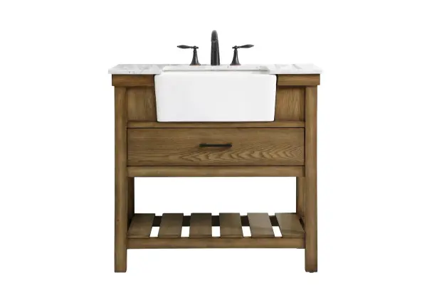 Make the most of your space with this farmhouse style bathroom vanity. Complements well with its beautiful finish, carrara white marble countertop, and the contemporary slender handle bar that sits on the functional drawers with soft closing mechanism, allowing you to store an assortment of bathroom essentials. The lower shelf makes it the perfect space to hold new towels for your guests. This stylish vanity ensures both form and function in your bathroom for you and your guests. Collection: Clement Rooms: bathroom Finish: driftwood Width: 22.00" Height: 34.13" Length: 36.00" Weight: 143.00 lb Material: Solid wood and MDF Country of Origin: Vietnam Manufacturer Warranty: 1 year limited