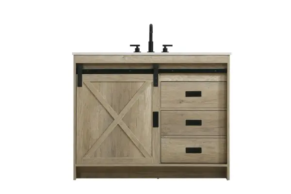 Transform your bathroom with this rustic barnyard-style vanity, designed to balance aesthetic appeal and functionality. Featuring a sliding barn door with black metal hardware and complementary handle pulls, this piece blends rugged charm with practical design. The engineered marble countertop displays unique marbling, while the porcelain undermount sink offers easy maintenance and durability. Available in Espresso, Natural Oak, and Rustic Grey finishes, this vanity suits a range of styles. It includes a deep storage drawer for larger items, a hidden shelf for towels or décor, and adjustable foot levelers for added stability on uneven floors. With pre-drilled faucet holes for easy setup, this vanity delivers style and substance to enhance your bathroom. Collection: Austin Rooms: bathroom Finish: Natural Oak Width: 42.00" Height: 22.00" Length: 42.00" Weight: 166.00 lb Material: MDF Country of Origin: Malaysia Manufacturer Warranty: 1 year limited