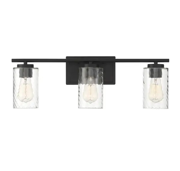 Make a big impact when you change out your old bathroom lights for this 3-light bath vanity light. It has a sleek look with intriguing shades of clear swirl glass and a matte black finish. Can be mounted with the shades facing up or down. 8.63" in height and 24" in width. Extends 5.5" from the wall. It uses 3 standard size bulbs of up to 60 watts per bulb, is LED compatible, is dimmable and is damp area rated. Collection: Mbath Rooms: Bathroom, Powder Room Finish: Matte Black Glass: Clear Swirl Width: 24.00" Height: 8.63" Weight: 3.96 lb Extension from Wall: 5.50" Canopy: 4.5"x7.88" Number of Bulbs: 3 Maximum Wattage: 60.00 W Bulb Type: ST19 Bulb Base: E26 Light Source: Incandescent/LED Dimmable Voltage: 120.00 V Material: Metal, Glass Safety Listing: UL/CUL Safety Rating: Damp LED