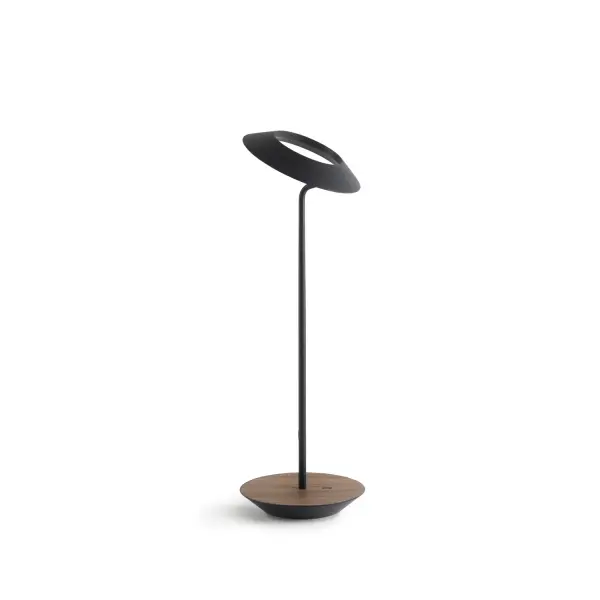 The Royyo Desk lamp adds an elegant flair to any space with its minimal wiring and pleasing circular design. Its minimal silhouette houses complex inner technology for a marriage of form and functionality. Royyo's embedded USB port allows users to charge any USB - compatible device. Interchangeable base plate options allow users to customize at ease. Achieve unity in design by inviting the Royyo Floor Lamp, Royyo Pendant and Royyo Desk Lamp into your home. Collection: Royyo Designer: Kenneth Ng, Edmund Ng Finish: Matte Black, Oiled Walnut Width: 6.40" Height: 17.40" Length: 6.40" Weight: 2.60 lb Bulbs Included Maximum Wattage: 11.00 W Bulb Type: LED Bulb Base: Integrated Light Source: LED Light Output: 600.00 lm Color Temperature: 3000 K CRI: 90 Voltage: 120.00 V Material: Aluminum, plastic Country of Origin: China Safety Listing: UL, CUL Safety Rating: Damp LED Manufacturer Warranty: 5 years Spec Sheet