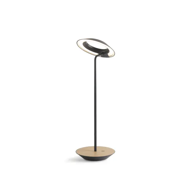 The Royyo Desk lamp adds an elegant flair to any space with its minimal wiring and pleasing circular design. Its minimal silhouette houses complex inner technology for a marriage of form and functionality. Royyo's embedded USB port allows users to charge any USB - compatible device. Interchangeable base plate options allow users to customize at ease. Achieve unity in design by inviting the Royyo Floor Lamp, Royyo Pendant and Royyo Desk Lamp into your home. Collection: Royyo Designer: Kenneth Ng, Edmund Ng Finish: Matte Black, White Oak Width: 6.40" Height: 17.40" Length: 6.40" Weight: 2.60 lb Bulbs Included Maximum Wattage: 11.00 W Bulb Type: LED Bulb Base: Integrated Light Source: LED Light Output: 600.00 lm Color Temperature: 3000 K CRI: 90 Voltage: 120.00 V Material: Aluminum, plastic Country of Origin: China Safety Listing: UL, CUL Safety Rating: Damp LED Manufacturer Warranty: 5 years Spec Sheet