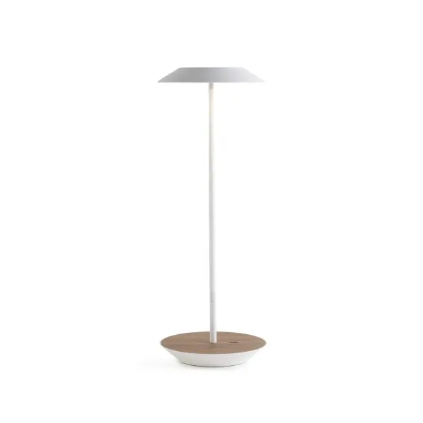 The Royyo Desk lamp adds an elegant flair to any space with its minimal wiring and pleasing circular design. Its minimal silhouette houses complex inner technology for a marriage of form and functionality. Royyo's embedded USB port allows users to charge any USB - compatible device. Interchangeable base plate options allow users to customize at ease. Achieve unity in design by inviting the Royyo Floor Lamp, Royyo Pendant and Royyo Desk Lamp into your home. Collection: Royyo Designer: Kenneth Ng, Edmund Ng Finish: Matte White, Oiled Walnut Width: 6.40" Height: 17.40" Length: 6.40" Weight: 2.60 lb Bulbs Included Maximum Wattage: 11.00 W Bulb Type: LED Bulb Base: Integrated Light Source: LED Light Output: 600.00 lm Color Temperature: 3000 K CRI: 90 Voltage: 120.00 V Material: Aluminum, plastic Country of Origin: China Safety Listing: UL, CUL Safety Rating: Damp LED Manufacturer Warranty: 5 years Spec Sheet