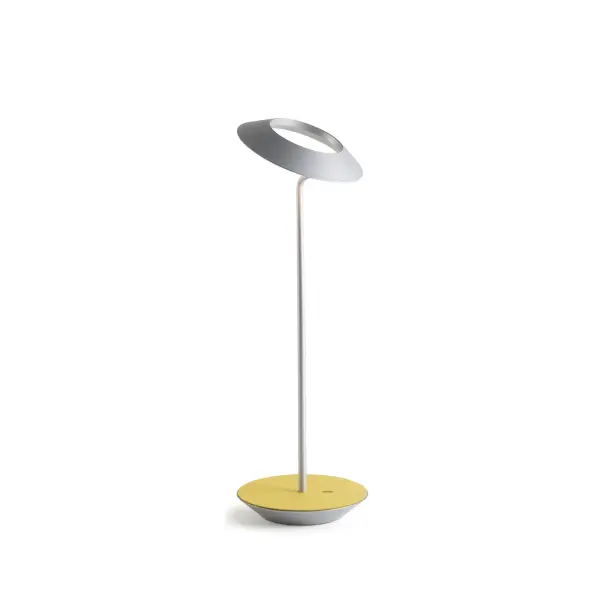 The Royyo Desk lamp adds an elegant flair to any space with its minimal wiring and pleasing circular design. Its minimal silhouette houses complex inner technology for a marriage of form and functionality. Royyo's embedded USB port allows users to charge any USB - compatible device. Interchangeable base plate options allow users to customize at ease. Achieve unity in design by inviting the Royyo Floor Lamp, Royyo Pendant and Royyo Desk Lamp into your home. Collection: Royyo Designer: Kenneth Ng, Edmund Ng Finish: Silver, Honeydew Felt Width: 6.40" Height: 17.40" Length: 6.40" Weight: 2.60 lb Bulbs Included Maximum Wattage: 11.00 W Bulb Type: LED Bulb Base: Integrated Light Source: LED Light Output: 600.00 lm Color Temperature: 3000 K CRI: 90 Voltage: 120.00 V Material: Aluminum, plastic Country of Origin: China Safety Listing: UL, CUL Safety Rating: Damp LED Manufacturer Warranty: 5 years Spec Sheet