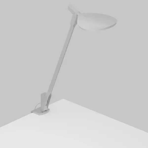 Inspired by the fluidity and formlessness of water droplets, Splitty Desk Lamp features fluid motion and ultra flexibility. The curved, droplet shape of the LED head reflects the root of its inspiration. It can be posed in virtually limitless ways, making it one of the most flexible lights on the market. Koncept designers perfected the diffused light source with hidden LEDs so that the lamp performs as a radiant ambient light as well as a functional task light. Users can avail of the discreet USB port to charge any compatible devices. The desk clamp allows users to maximize their work space by mounting the light to the edge of their desk or any surface up to 2.3" thick. Collection: Splitty Designer: Kenneth Ng, Edmund Ng Finish: Silver Width: 5.00" Height: 16.05" Length: 8.20" Weight: 1.20 lb Bulbs Included Maximum Wattage: 7.00 W Bulb Type: LED Bulb Base: Integrated Light Source: LED Light Output: 500.00 lm Color Temperature: 3500 K CRI: 90 Voltage: 120.00 V Material: Aluminum, plastic Country of Origin: Taiwan Safety Listing: UL/cUL Safety Rating: Dry LED Manufacturer Warranty: 5 years Spec Sheet
