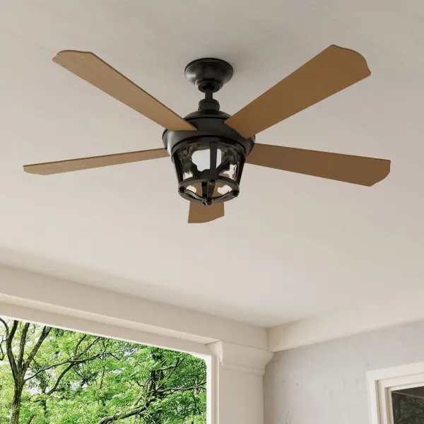 The Smyrna 52" ceiling fan combines traditional styling with modern versatility, featuring a durable Antique Bronze finish suitable for both indoor and outdoor spaces. Five blades provide efficient air circulation.