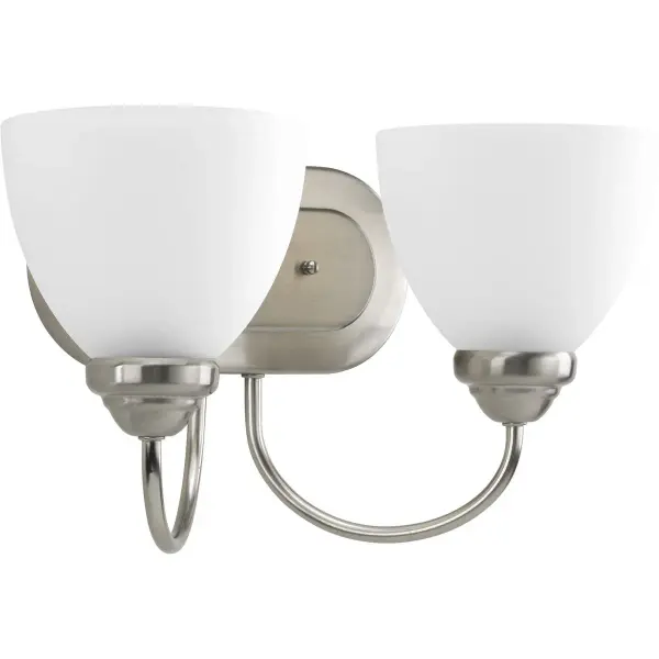 The Heart Collection vanity light combines timeless farmhouse style with practical two-light illumination. Etched glass shades soften the light while brushed nickel finish adds refined elegance to any bathroom. - alternate view