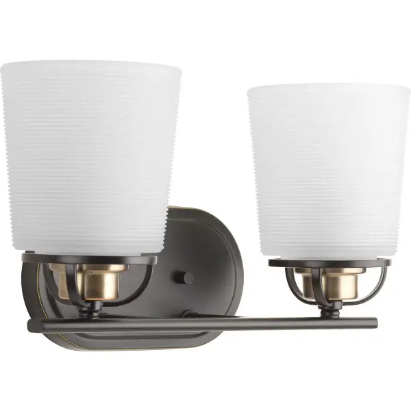 The West Village vanity light combines vintage-inspired etched prismatic glass with contemporary brushed nickel finish. Two lights provide ample illumination for grooming tasks while the timeless design complements both traditional and transitional bathrooms.