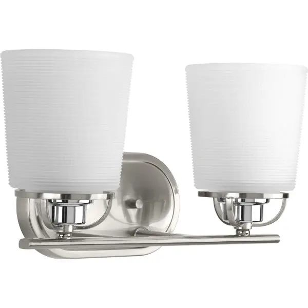 The West Village vanity light combines vintage-inspired etched prismatic glass with contemporary brushed nickel finish. Two lights provide ample illumination for grooming tasks while the timeless design complements both traditional and transitional bathrooms. - alternate view