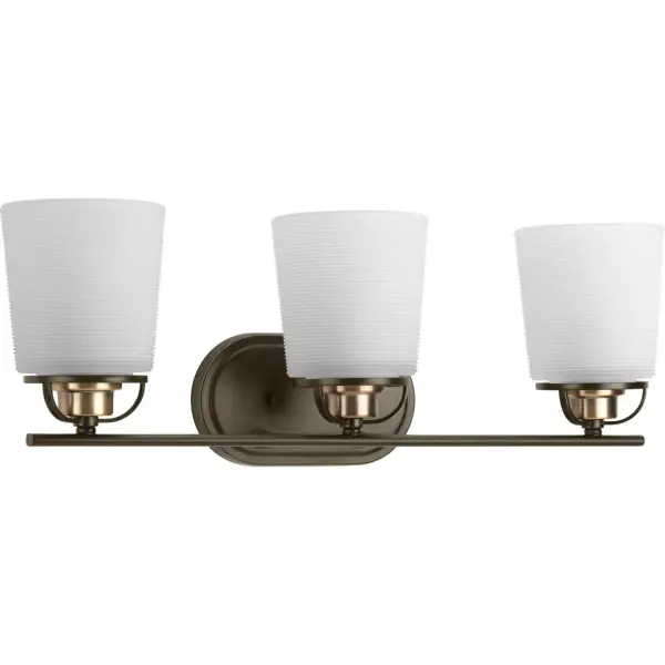 A modern form with industrial-inspired accents are featured in West Village. Double prismatic glass shades provide a beautiful illumination effect. Visual interest continues with a three-spoke design that holds each glass shade. Antique Bronze with Antique Brass accents provide touches of mixed metal. The three-light bath fixture can be installed with glass facing up or down. This fixture is part of our Design Series collections. Collection: West Village Rooms: Bathroom Finish: Antique Bronze Glass: Etched Double Prismatic Width: 23.25" Height: 8.13" Weight: 7.46 lb Extension from Wall: 7.00" Top to Outlet: 6.00" Wire: 6" Canopy: 0.875"x4.4375"x8" Number of Bulbs: 3 Maximum Wattage: 100.00 W Bulb Type: A19 Bulb Base: E26 Light Source: Incandescent Voltage: 120.00 V Material: Steel Country of Origin: CN Safety Listing: cULus Safety Rating: Damp Title 20 Manufacturer Warranty: 1-year Limited Warranty Spec Sheet Instructions Parts Diagram