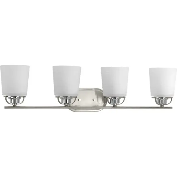 A modern form with industrial-inspired accents are featured in West Village. Double prismatic glass shades provide a beautiful illumination effect. Visual interest continues with a three-spoke design that holds each glass shade. Brushed Nickel with chrome accents provide touches of mixed metal. The four-light bath fixture can be installed with glass facing up or down. This fixture is part of our Design Series collections. Collection: West Village Rooms: Bathroom Finish: Brushed Nickel Glass: Etched Double Prismatic Width: 32.25" Height: 8.13" Weight: 9.57 lb Extension from Wall: 7.00" Top to Outlet: 6.00" Wire: 6" Canopy: 0.875"x4.4375"x8" Number of Bulbs: 4 Maximum Wattage: 100.00 W Bulb Type: A19 Bulb Base: E26 Light Source: Incandescent Voltage: 120.00 V Material: Steel Country of Origin: CN Safety Listing: cULus Safety Rating: Damp Title 20 Manufacturer Warranty: 1-year Limited Warranty Spec Sheet Instructions Parts Diagram