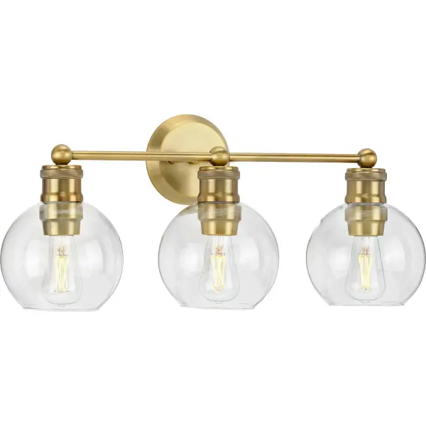 The Hansford vanity light combines transitional elegance with farmhouse charm. Three clear glass shades and antique bronze finish create warm, functional lighting perfect for bathroom vanities and powder rooms.