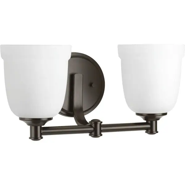 The Topsail vanity light brings coastal charm to bathroom spaces with its antique bronze finish and soft etched parchment glass shades. Two-light configuration provides balanced illumination for vanity tasks.