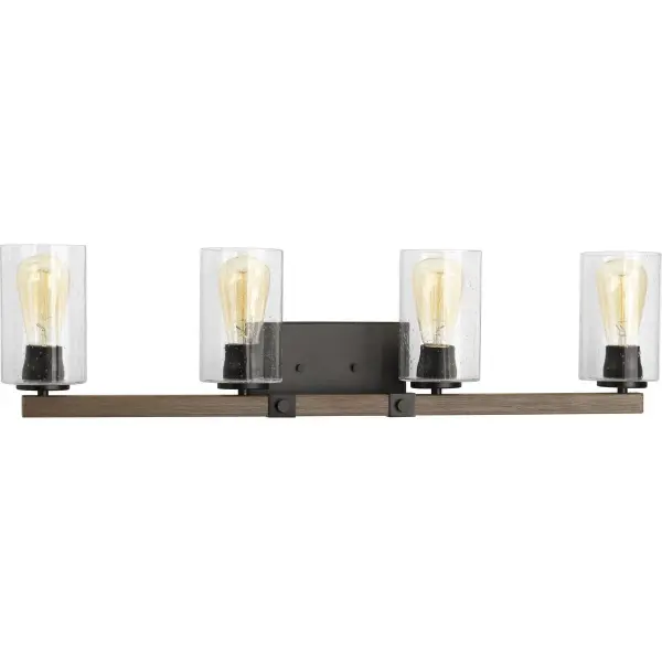 The Barnes Mill vanity light brings authentic farmhouse character with its antique bronze finish and clear seeded glass shades. Four lights provide ample illumination for grooming tasks while the vintage-inspired design adds warmth.