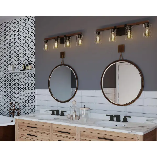 The Barnes Mill vanity light brings authentic farmhouse character with its antique bronze finish and clear seeded glass shades. Four lights provide ample illumination for grooming tasks while the vintage-inspired design adds warmth. - alternate view