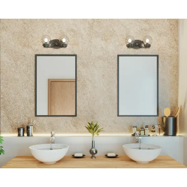 The Spatial Collection vanity light combines contemporary black finish with clear glass shades for a clean, modern aesthetic. Perfect for bathrooms seeking functional lighting with minimalist style. - alternate view