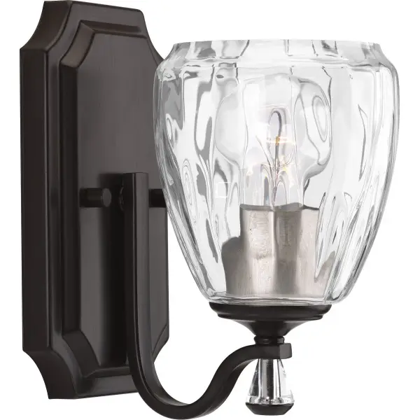The Anjoux vanity light combines traditional styling with clear water glass for a timeless look. Its antique bronze finish and single-light design make it perfect for smaller bathrooms or powder rooms seeking refined illumination.