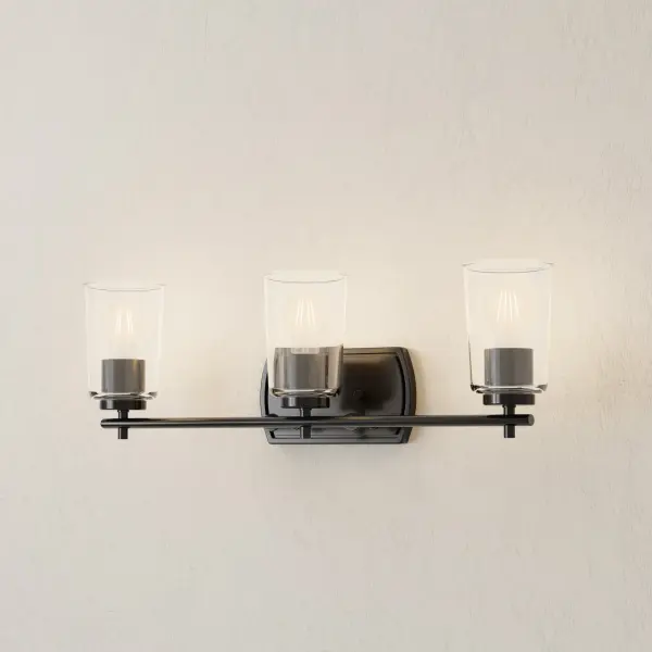 The Adley Collection combines classic styling with modern functionality, featuring three lights behind clear glass shades and a refined brushed nickel finish. Perfect for traditional and transitional bathrooms seeking quality illumination. - alternate view