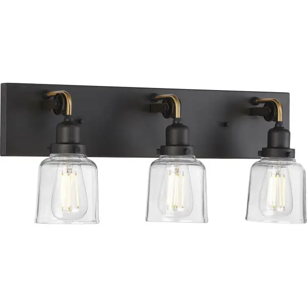 The Rushton vanity light blends urban industrial style with farmhouse warmth through clear glass cylinders and brushed nickel finish. Three lights provide ample illumination for grooming tasks while adding architectural interest. - alternate view