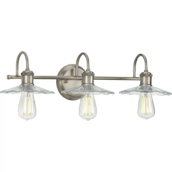 Inspired from early electric lighting, this bath light will infuse your home with a sense of history. A simple antique nickel bar attached to a backplate supports curved arms bending to hold vintage-style light bases. Petal-like light shades crafted from clear depression glass for a must-have, artistic touch complete the design. Collection: Fayette Rooms: Bathroom Finish: Antique Nickel Glass: Clear Width: 25.50" Height: 6.50" Length: 25.50" Weight: 4.18 lb Extension from Wall: 9.00" Wire: 6" Canopy: 5.125"x1"x5.125" Number of Bulbs: 3 Maximum Wattage: 60.00 W Bulb Type: A19 Bulb Base: E26 Light Source: Incandescent Voltage: 120.00 V Material: Steel Country of Origin: CN Safety Listing: cULus Safety Rating: Damp Title 20 Manufacturer Warranty: 1-year Limited Warranty Spec Sheet Parts Diagram