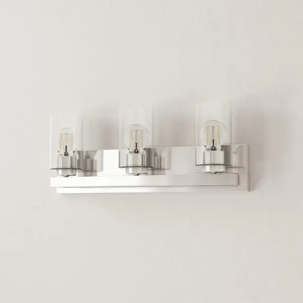 The Goodwin three-light vanity fixture combines contemporary styling with practical illumination. Brushed nickel finish and clear glass shades create a versatile look that complements modern and transitional bathrooms.