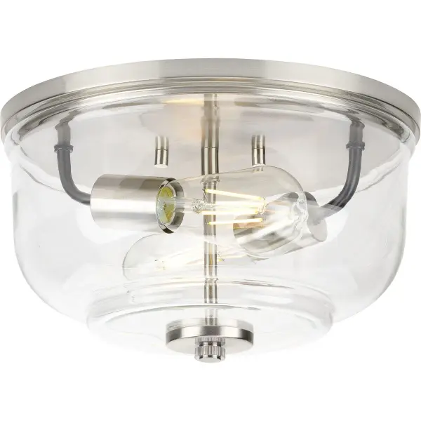 The Rushton flush mount combines farmhouse charm with industrial edge, featuring clear glass shades and brushed nickel finish. Perfect for low-ceiling spaces, this two-light fixture provides ample illumination while maintaining a compact profile. JA8 and Title 22 compliant for California installations. - alternate view