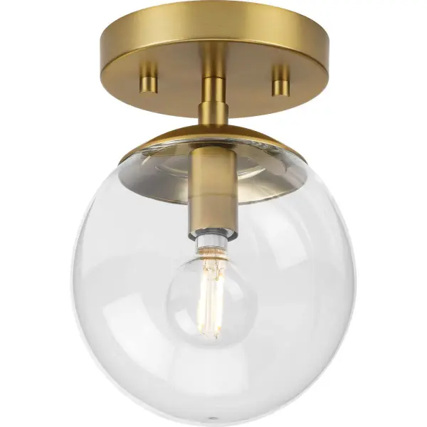 The Atwell semi-flush mount delivers clean mid-century styling with a brushed nickel finish and glass shade. Its compact profile makes it ideal for bedrooms, hallways, and foyers with standard ceiling heights.