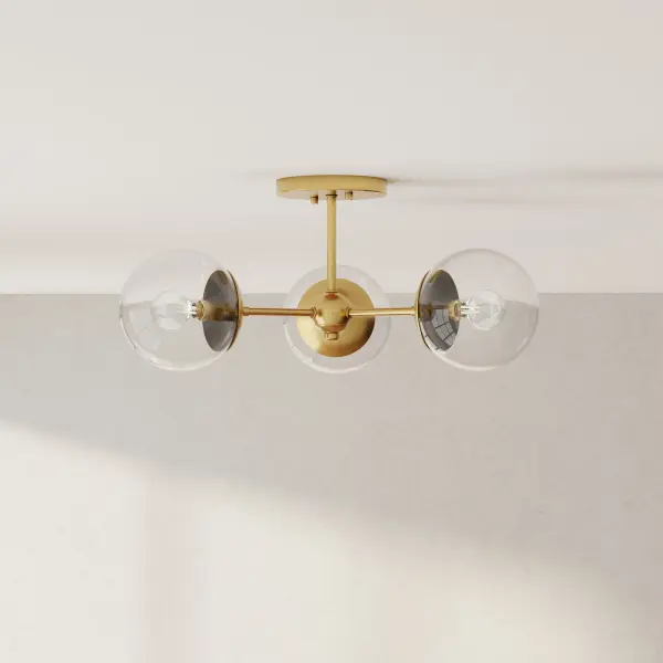 The Atwell semi-flush mount combines timeless mid-century aesthetics with contemporary finishes. Its three-light configuration provides ample illumination while maintaining a low profile perfect for standard ceiling heights.