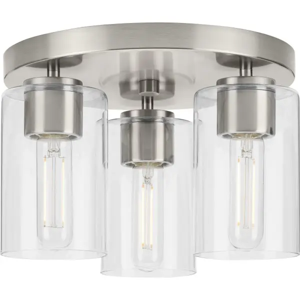 The Cofield flush mount combines mid-century modern styling with practical functionality. Its 12-inch profile and three-light configuration provide ample illumination while maintaining a low profile ideal for standard ceiling heights.