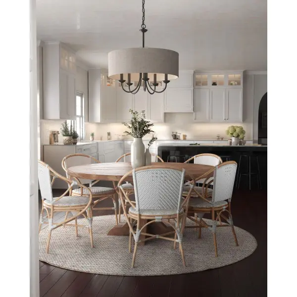 This five-light chandelier combines rustic farmhouse charm with transitional versatility. The harvest linen drum shade diffuses light beautifully while the black finish adds modern contrast, making it perfect for dining rooms and kitchens. - alternate view