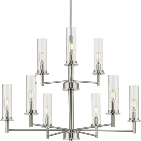 The Kellwyn chandelier combines brushed nickel metalwork with clear glass shades for a sophisticated look that bridges traditional and contemporary design. Nine lights provide ample illumination for large spaces.