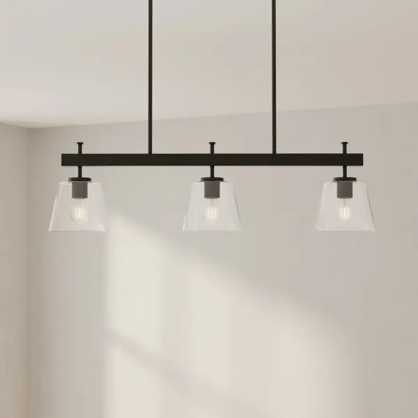 The Saffert linear chandelier combines urban industrial style with transitional versatility. Three clear glass shades suspended from a brushed nickel frame deliver focused task lighting perfect for kitchen islands and dining tables. - alternate view
