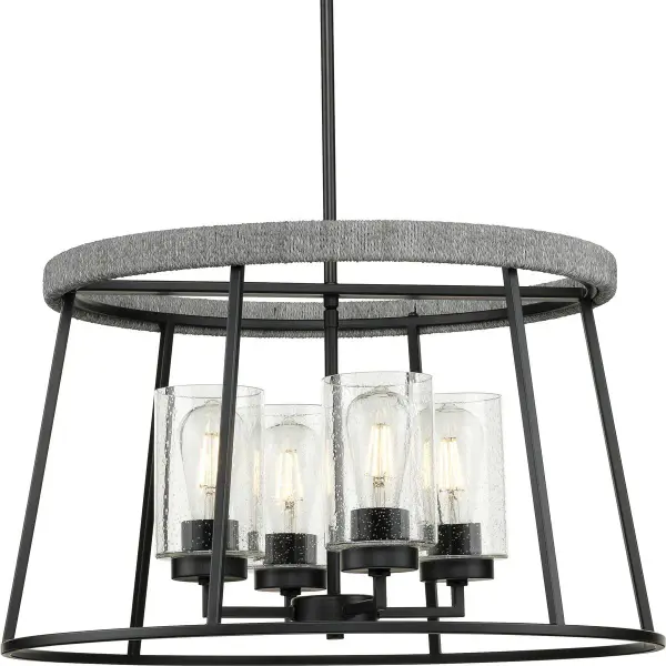 The Laramie chandelier combines industrial-inspired matte black metalwork with clear seeded glass shades for authentic rustic character. Its compact three-light design delivers focused illumination perfect for intimate dining spaces and breakfast nooks.