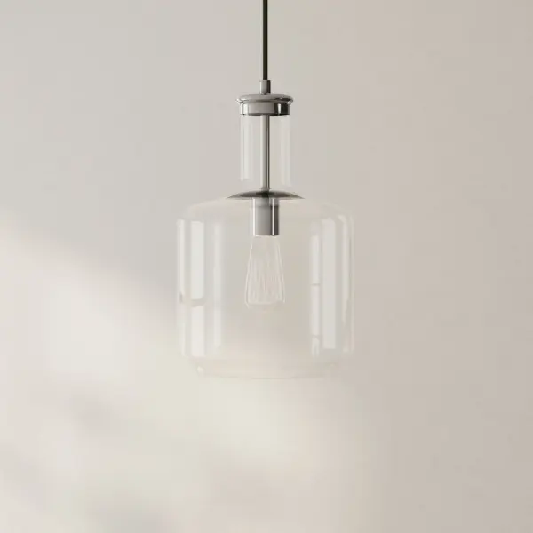 The Latrobe pendant combines coastal-inspired clear glass with a brushed nickel finish, creating a versatile fixture perfect for kitchen islands and dining areas. Its clean lines and transparent shade provide ample light distribution while maintaining an airy, open feel.