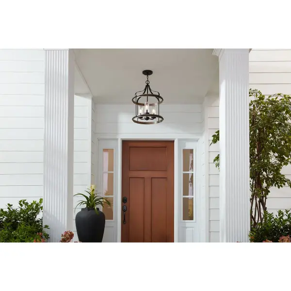 The Brenham outdoor pendant brings rustic farmhouse style to covered exterior spaces with its three-light configuration and black finish. JA8 compliant for California energy standards, this fixture balances aesthetic appeal with practical outdoor performance. - alternate view