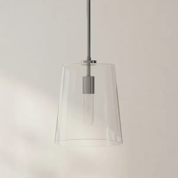 The Clarion pendant combines clean lines with coastal charm through its clear glass shade and brushed nickel finish. Perfect for kitchen islands or dining areas, this single-light fixture offers versatile style and JA8 compliance.