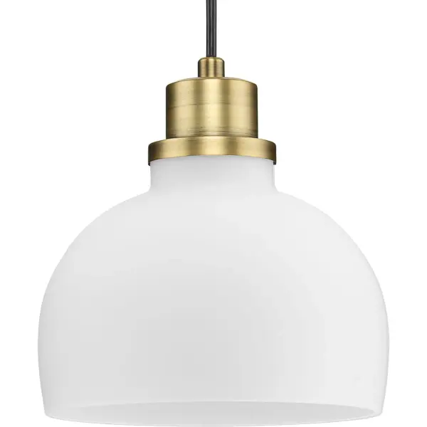 The Garris mini-pendant combines transitional elegance with farmhouse charm, featuring etched opal glass that diffuses light beautifully. Its compact size and vintage brass finish make it perfect for kitchen islands, dining nooks, or clustered installations.