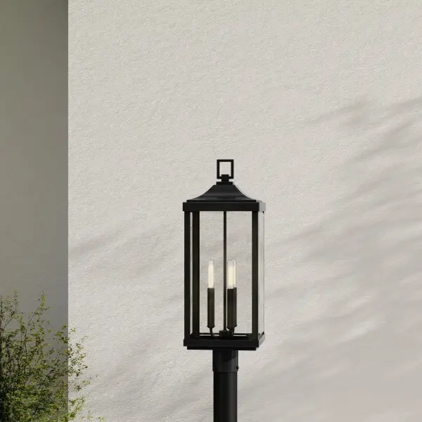 The Gibbes Street post lantern brings traditional elegance to outdoor spaces with its three-light design and antique bronze finish. Perfect for illuminating pathways, driveways, and entryways with classic charm. - alternate view